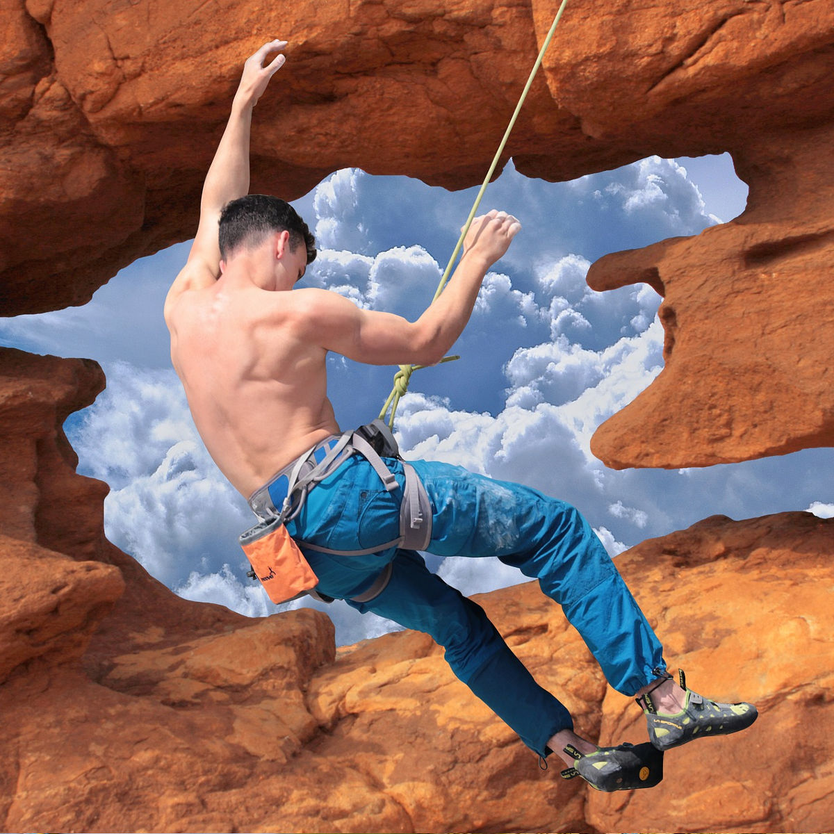 Climber swinging on the climbing rope